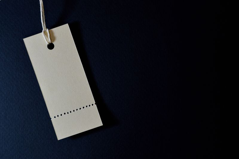 A blank paper price tag on a dark blue background